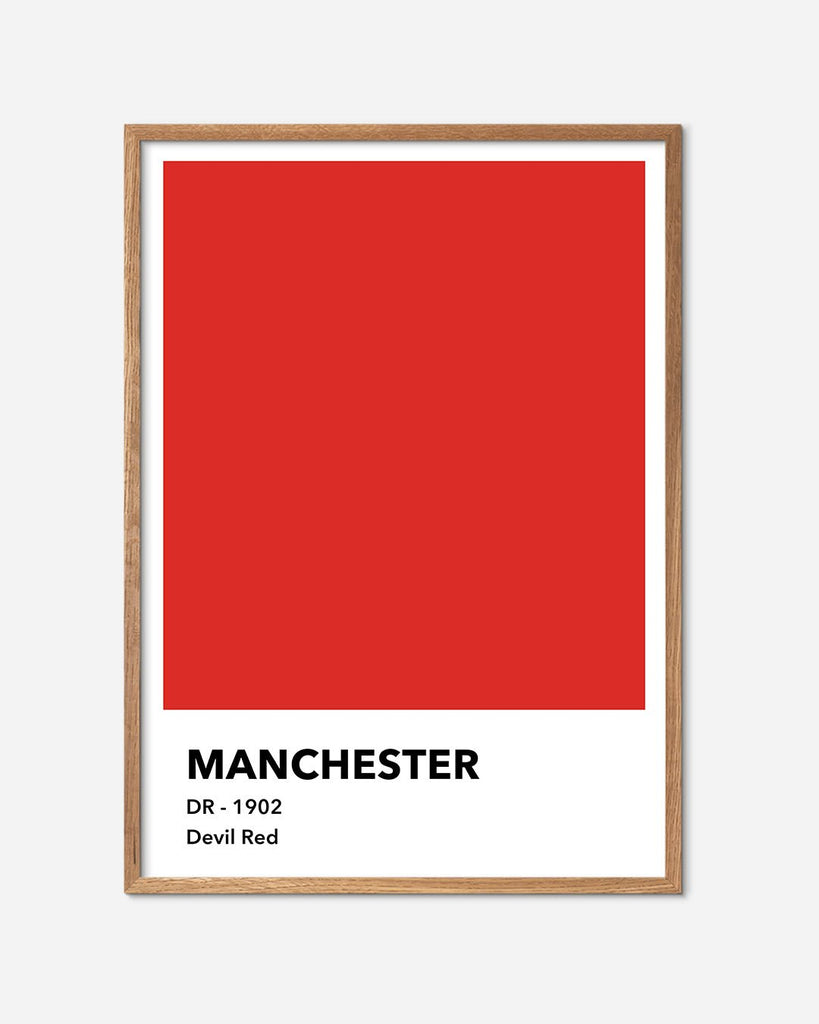 En Manchester United fodbold plakat med deres røde farve fra Colors kollektionen i en egetræsramme - Olé Olé
